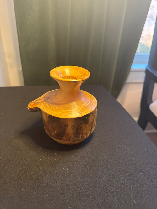 Hand-turned wooden decorative piece with carved figure by Spinning Aspen Studios.